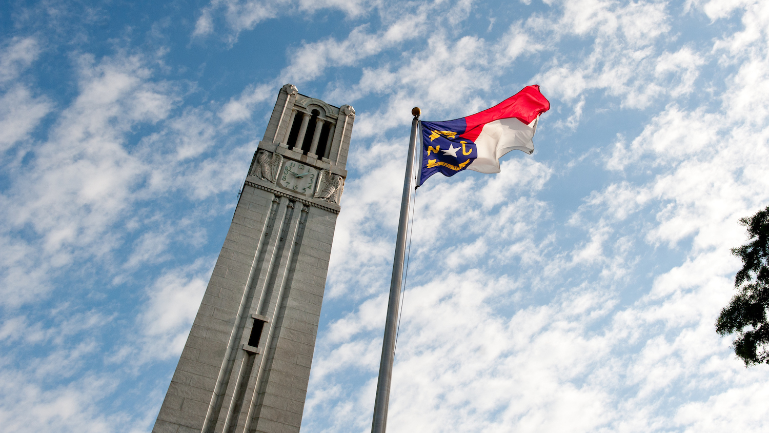 NC State Belltower and flag of North Carolina