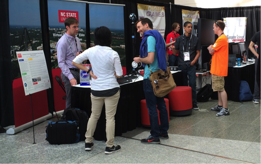 Visitors inquiring about VR at NC State booth at East Coast Games Conference