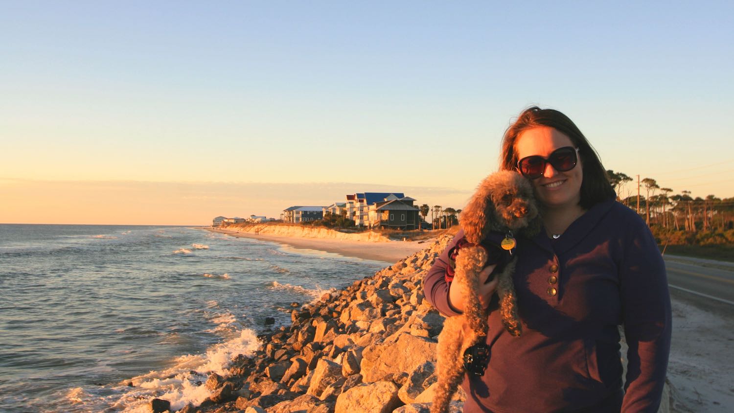 Katie Bean and her dog named Coco Bean at St. George Island, Florida by the ocean.