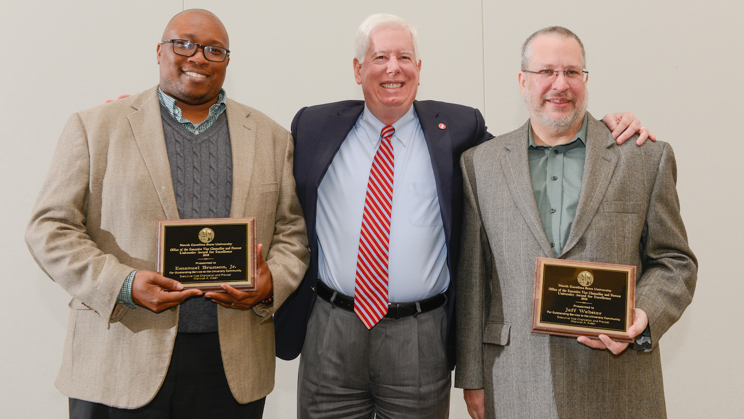 Awards for Excellence recipients Emanuel Brunson (left) and Jeff Webster (right) pictured with Senior Vice Provost Tom Miller (center) at the reception ceremony March 21, 2018 in Talley Student Union. Photo by Marc Hall.