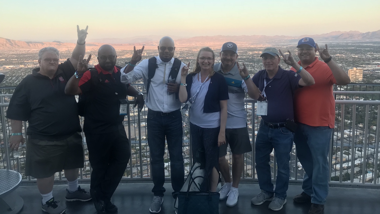Left to right: Darren Ley, Tony Pearson, Shawn Colvin, Donna Petherbridge, Tim Hinds, Bob Klein and Brandon Pope in Las Vegas for the UBTech conference and InfoComm trade show. The group is standing on a balcony in front of the skyline.