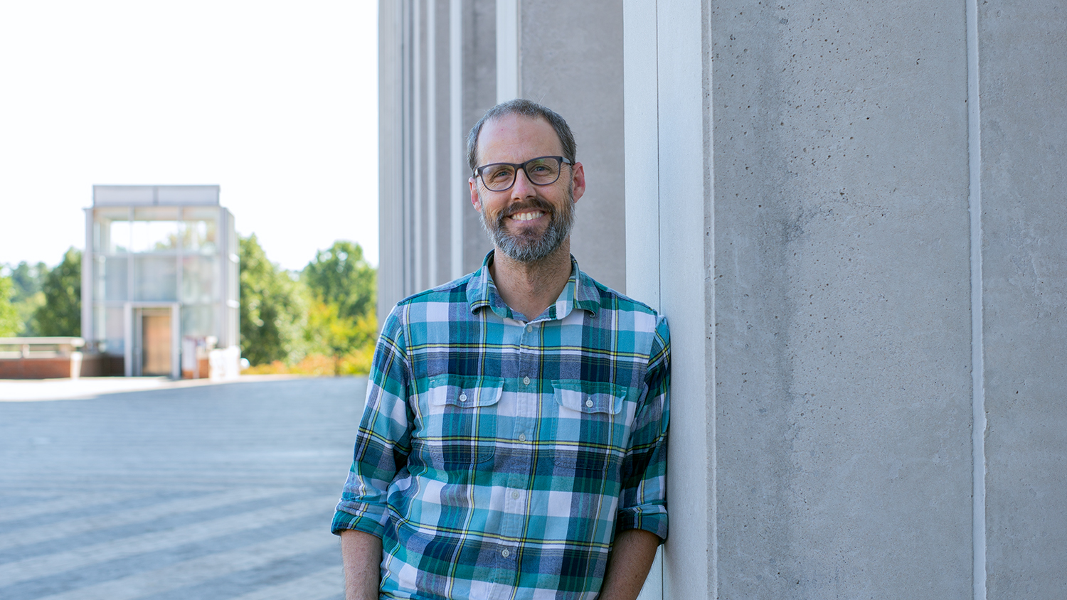 Alan McCoy pictured leaning up against a pillar on Centennial Campus.