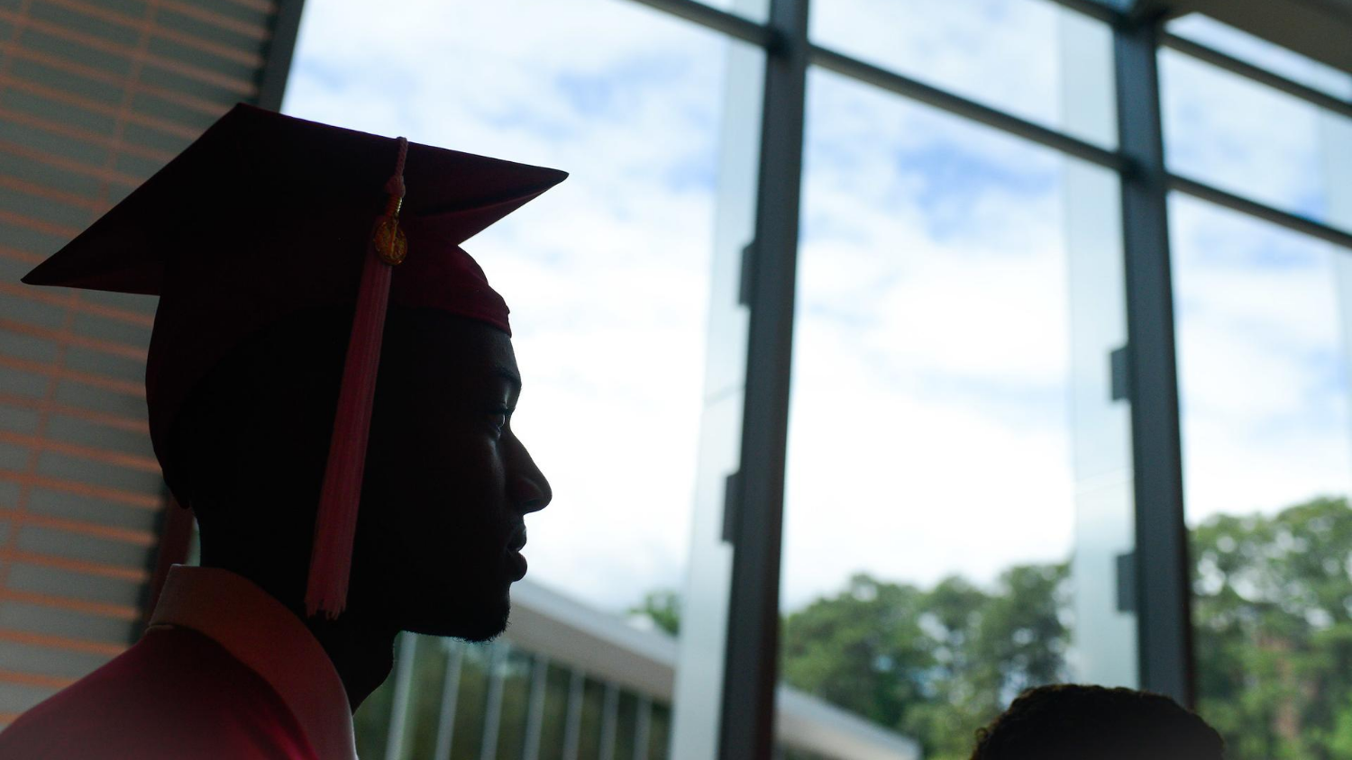 Silhouette of student in graduation cap.