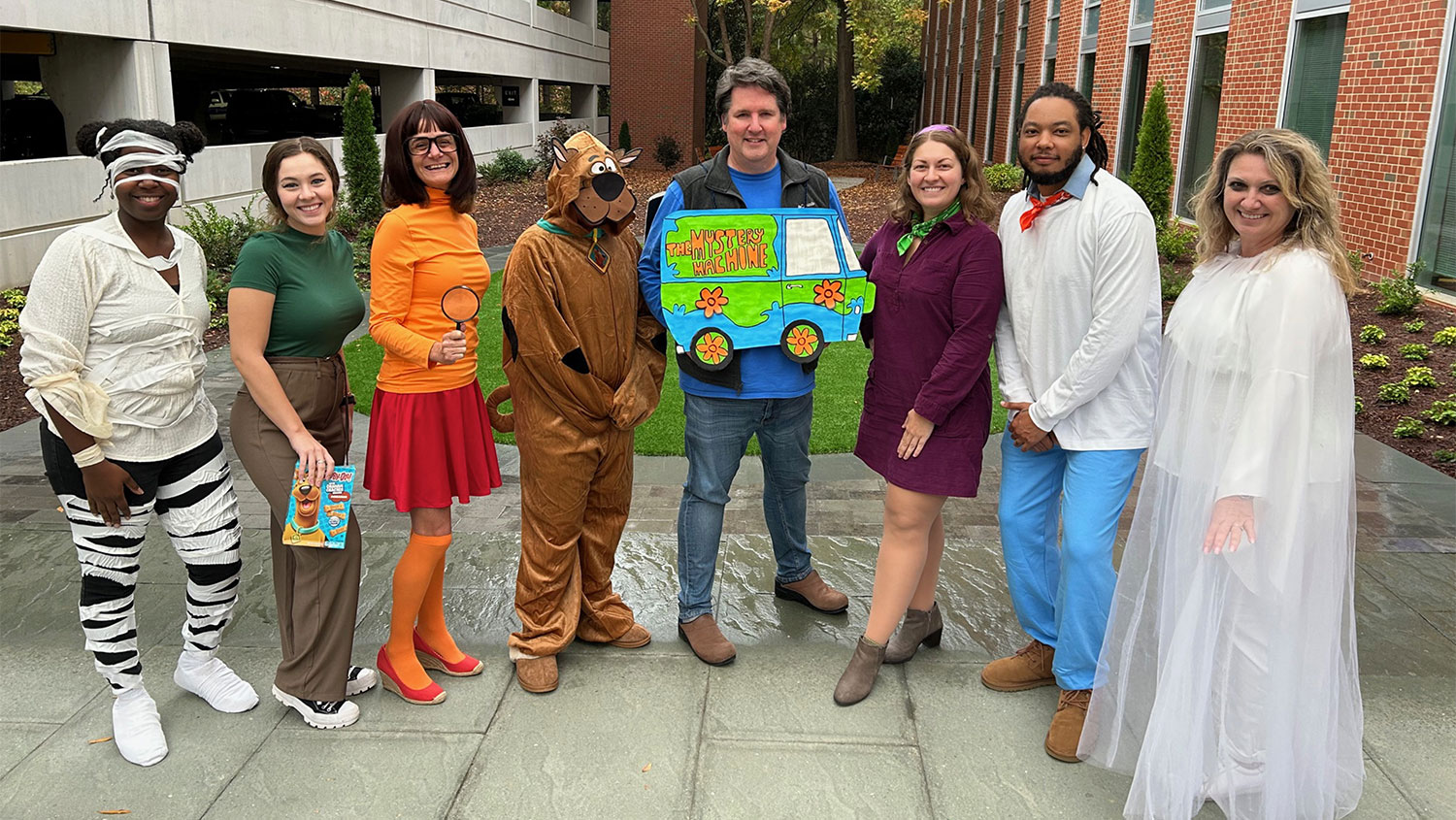 DELTA Testing Services standing outside dressed in Scooby Doo Halloween costumes