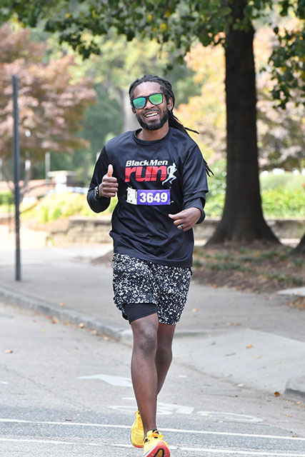 Relly Moorer running the City of Oaks marathon on a city street in Raleigh, North Carolina