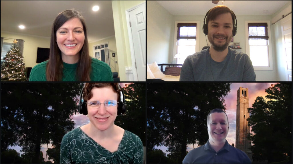 A screenshot of a zoom call with four people smiling.