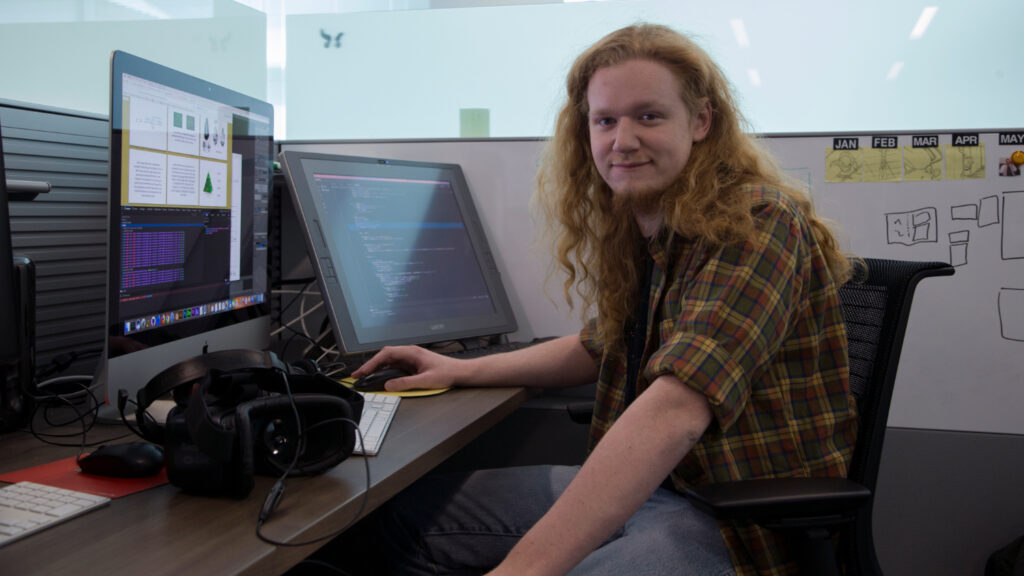 A man sitting at a workstation in an office