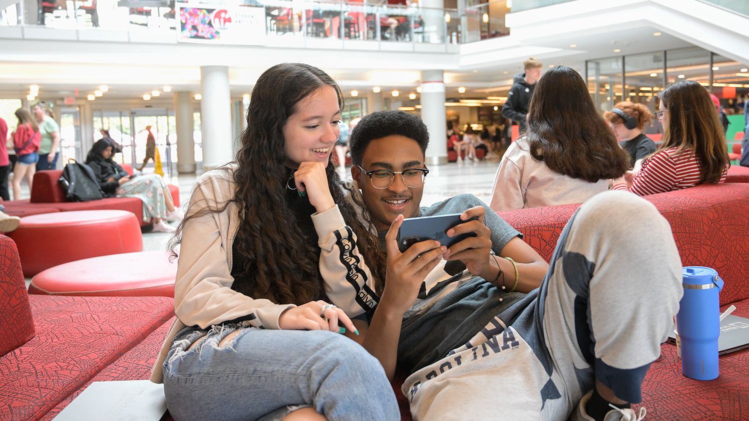 Students enjoy a moment watching a funny video while take a break between classes at the Talley Student Union on main campus.