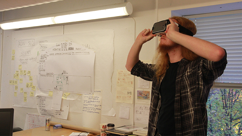 A man using a VR headset in a classroom